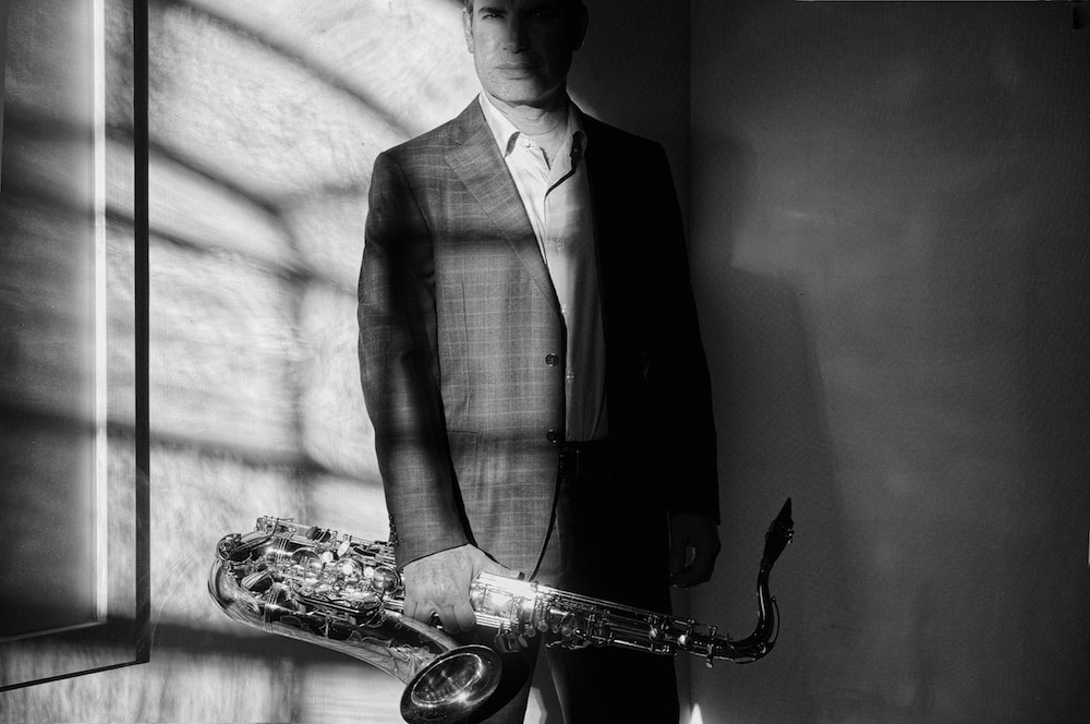 Matthew Levy standing with saxophone