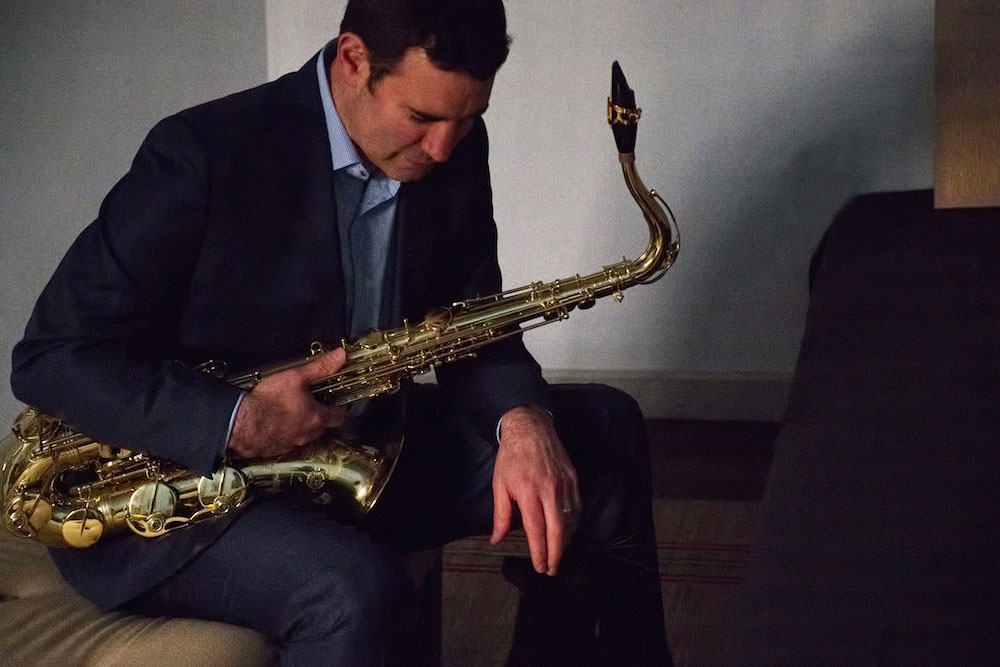 Matthew Levy seated with saxophone